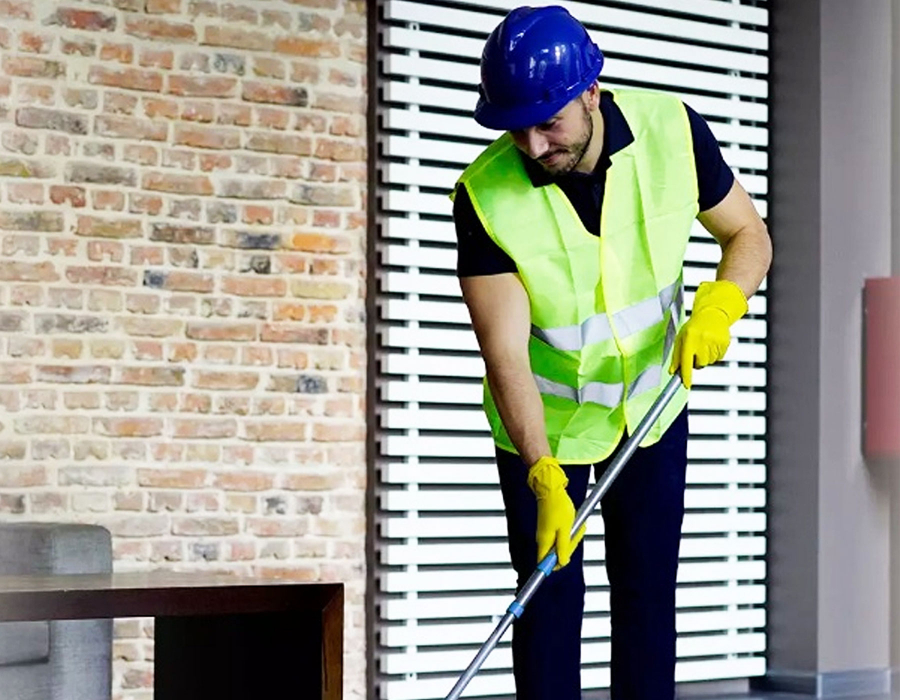cleaner mopping the floor after builders work