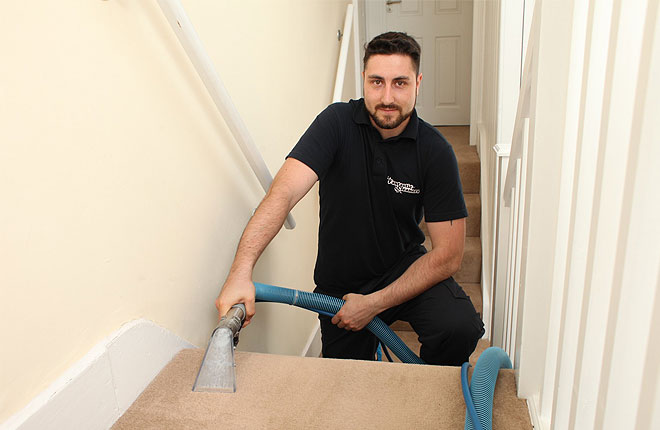 Carpet cleaner vacuuming stairs