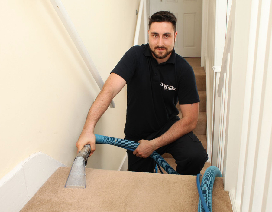 Carpet cleaner vacuuming stairs