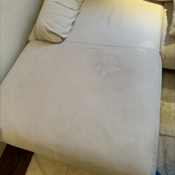Stained sofa before professional carpet cleaning