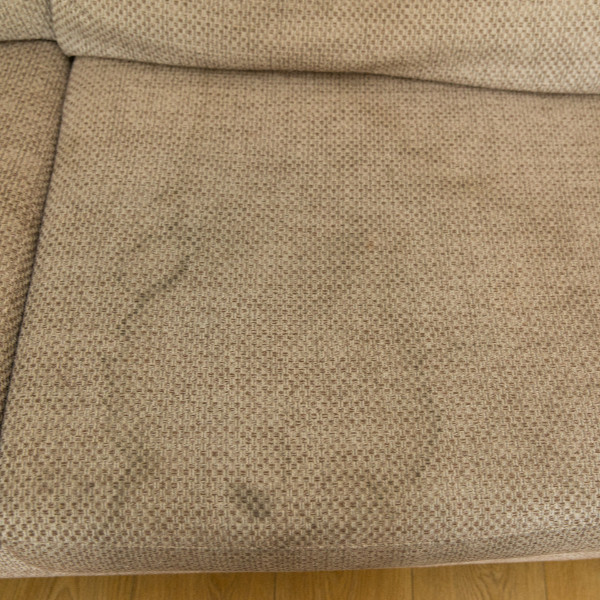 Cream sofa before upholstery cleaning with visible marks