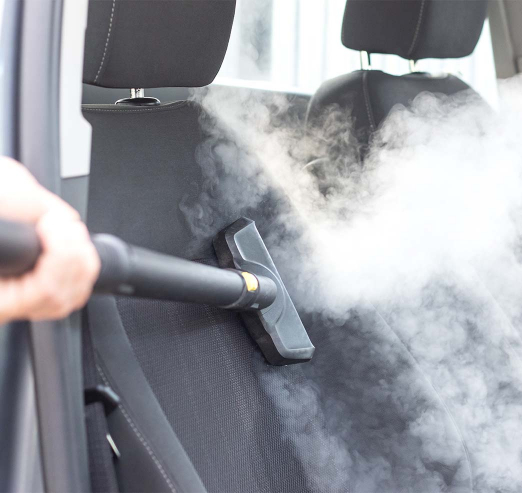 Car seat being professionaly steam cleaned
