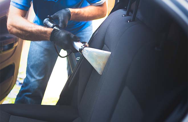 Car cleaning professional performing car interior deep cleaning service