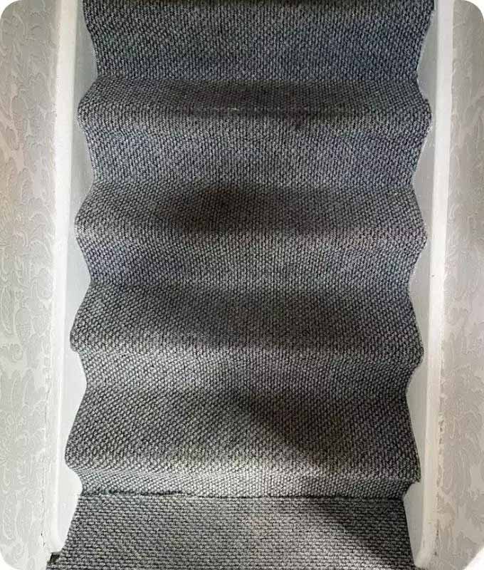 Stained staircase carpeting before cleaning