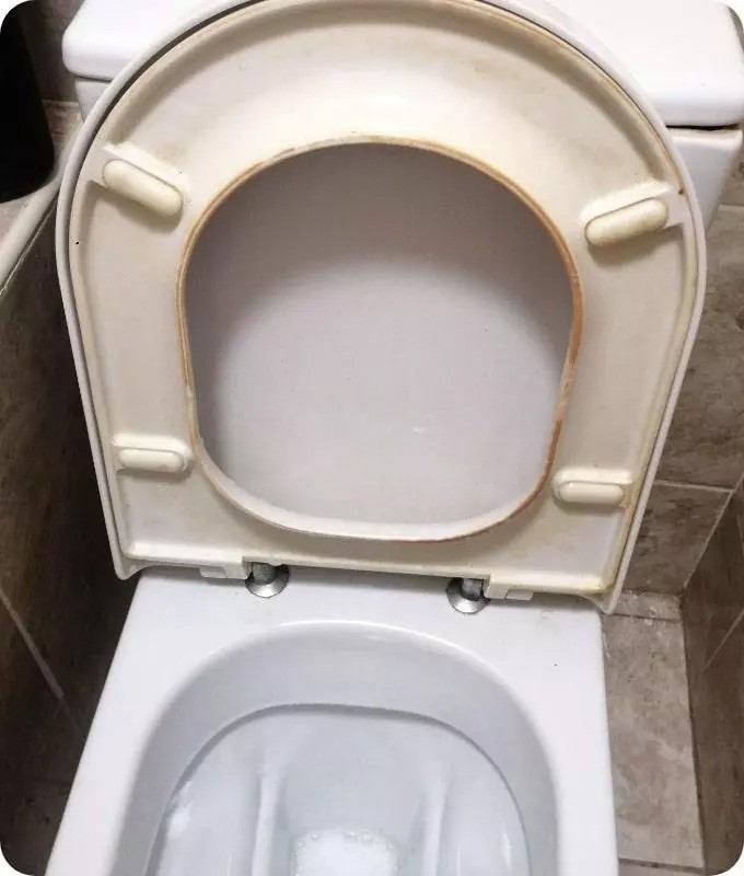 Stained toilet in a London property before professional cleaning service